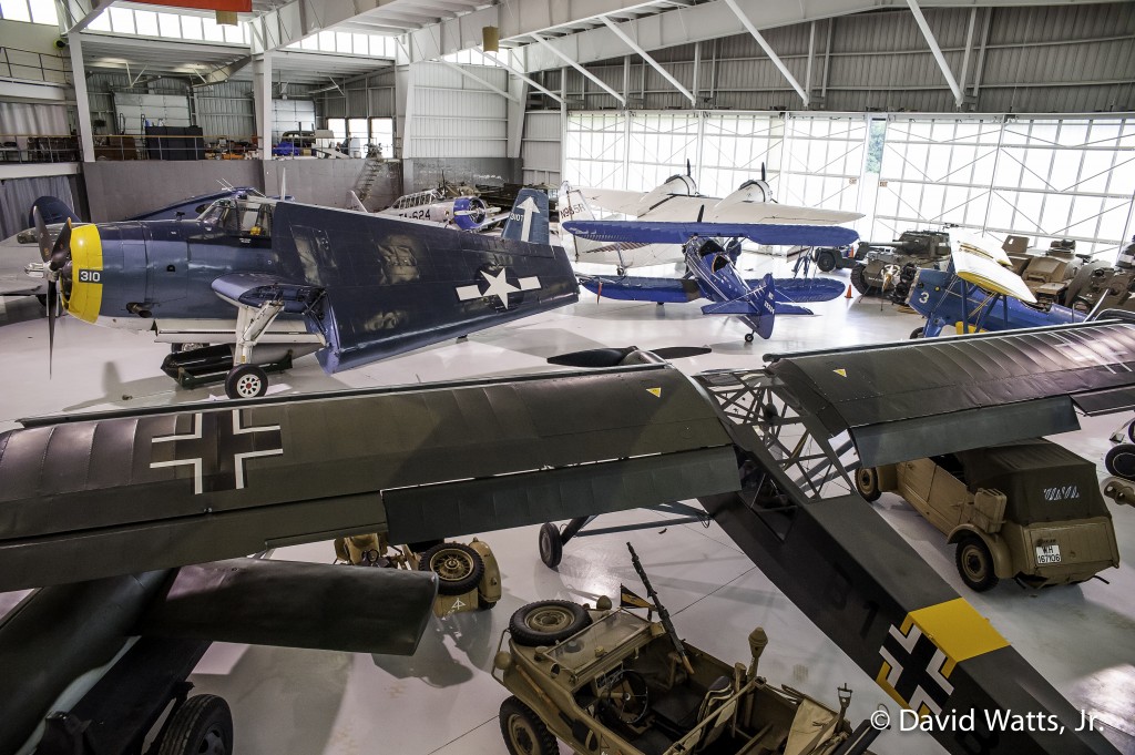 Collings Foundation Wings & Wheels / American Elegance - A view of the lower ground level of the hanger. Clockwise from upper center: Grumman TBM Avenger torpedo bomber, North American AT-6 Texan, Grumman G-21 Goose, Waco UPF-7 biplane, Boeing PT-17 Stearman "Kaydet," VW Kübelwagen, Fieseler Fi-156 Storch observation aircraft, VW Schwimmwagen, V-1 buzz bomb.