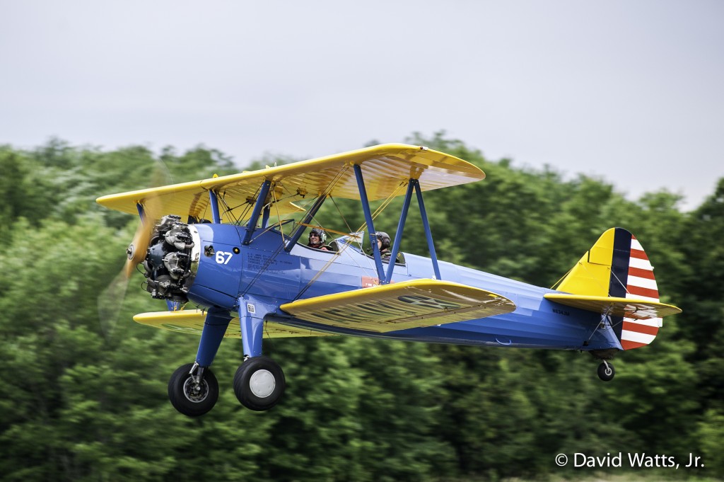 Collings Foundation Wings & Wheels / American Elegance - Boeing PT-17 Stearman "Kaydet" flight experience flying from Minuteman Airfield in Stow, MA. This vintage Stearman, once a training aircraft for the Tuskegee Airmen during World War II, is piloted by C.F. CEO and Chief Pilot Rob Collings.